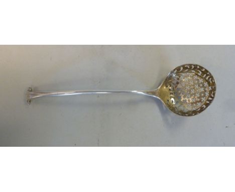 A George III silver Onslow pattern sifter spoon with a foliate scrolled, star and flowerhead pierced bowl  makers mark indist