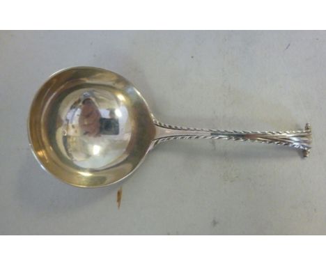 A George III silver Onslow pattern caddy spoon with a feather edged stem  indistinct marks