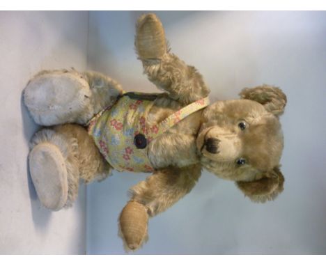 A 1930s Chiltern Hugmee beige mohair Teddy bear with glass eyes and mobile limbs  17.5''h