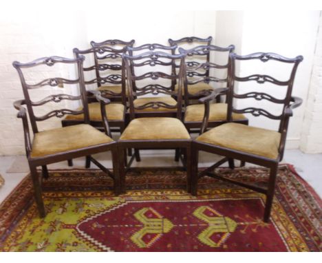 A set of eight 1920s mahogany dining chairs, each having a carved, pierced ladder back, the dralon upholstered seat raised on
