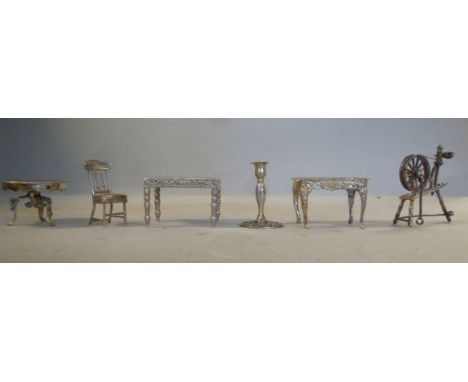 Modern silver and white coloured metal miniature model domestic artefacts and furniture, viz. a spinning wheel; a candlestick