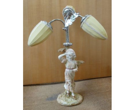 A late Victorian Royal Worcester blush ivory glazed porcelain table lamp, featuring a woman standing beside a tree, surmounte