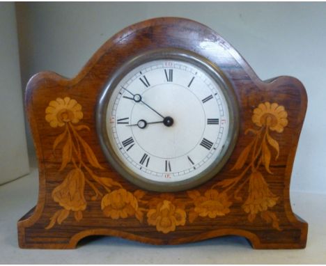 An early 20thC mahogany and walnut, arched block cased mantel timepiece with floral marquetry ornament, on cut-out bracket fe