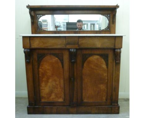 An early Victorian rosewood chiffonier, the low, level, brass galleried, mirror backed upstand with a shallow shelf, on C-scr