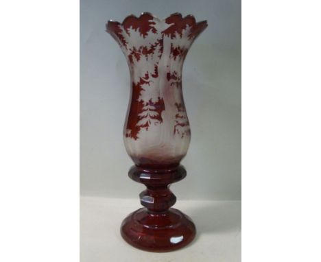 A late 19thC Bohemian ruby and clear glass vase, having a castellated flared rim, over a wheel engraved forest scene with sta