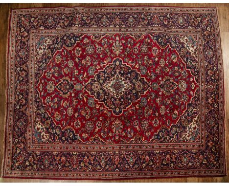 Ardekan red and blue ground wool carpetIranian, with floral and foliate designs in and around a central panel, 235cm x 294cmW