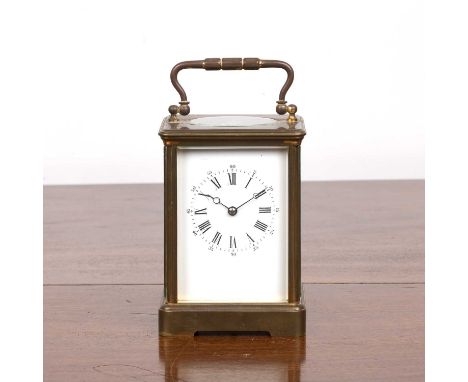 French eight-day brass carriage clock with keythe white enamel dial with black Roman numerals, stamps to the reverse of the m