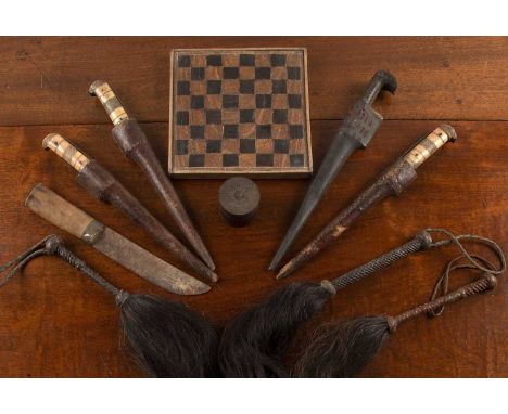 Collection of three bone handled and two other tribal daggerswith three fly whisks, a small chessboard, and a hardwood box (1