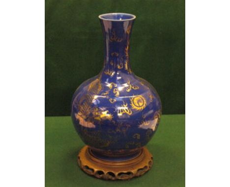 BLUE CERAMIC VASE WITH GILDED CHINESE DRAGON DECORATION, ON CARVED TREEN STAND, APPROXIMATELY 42cm HIGH  