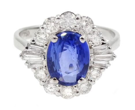 18ct white gold sapphire and diamond cluster ring, the central oval sapphire of approx 2.10 carat, with tapered baguette diam