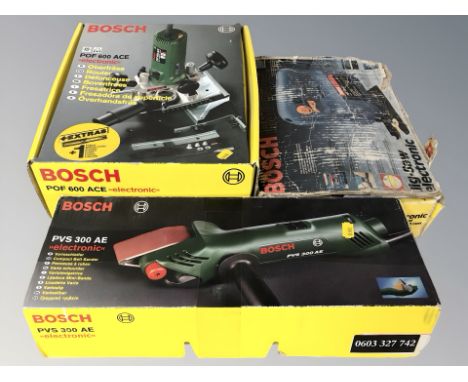 Three boxed Bosch power tools to include compact belt sander, router and jigsaw. (1 box)