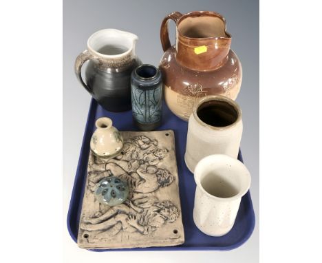 A group of stoneware jugs and vessels, Celtic pottery vase, relief panel depicting figures, etc.
