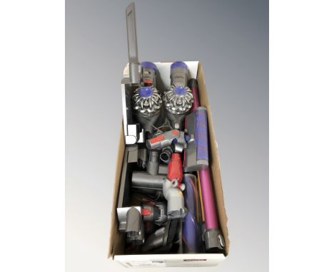 Two Dyson stick vacuum cleaners and various attachments. (1 box)