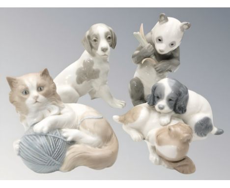Four various Nao figures of puppies, a cat and a panda, tallest 16 cm.