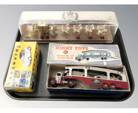 A Dinky Toys 982 Pullmore car transporter, a Lledo Vanguards Morris Minor convertible and a Queen's silver jubilee royal stat