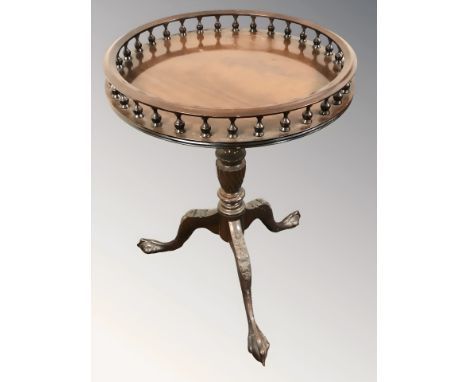 A reproduction mahogany circular tripod table with galleried top, on claw and ball feet, height 63 cm.