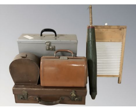 A group of vintage luggage cases, further metal tin, a bamboo parasol, a pine and galvanised metal washboard.