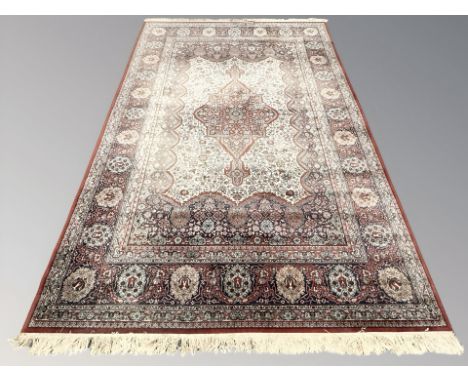 A machine-made carpet of Persian design, 309 cm x 204 cm 