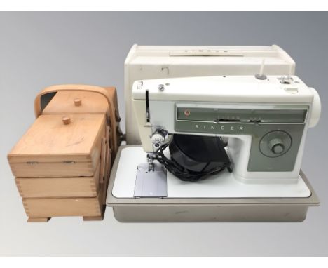 A Singer electric sewing machine and a Concertina sewing box.