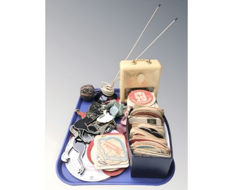 A large quantity of coasters with various advertising, a vintage Smiths Timecal clock, wall plaques, etc.