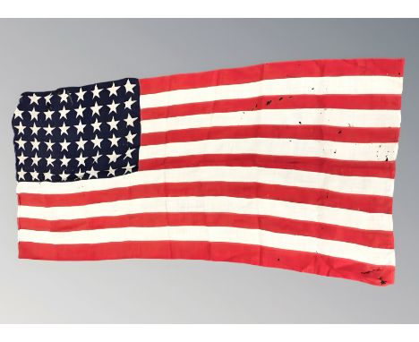 A vintage American flag with forty eight stars, 180 cm x 84 cm. CONDITION REPORT: Numerous holes.