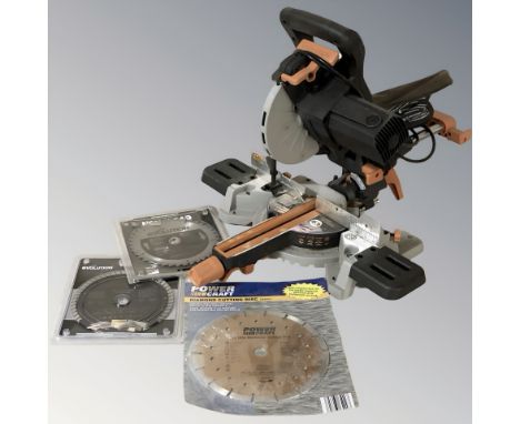 An Evolution compound mitre saw and several blades.