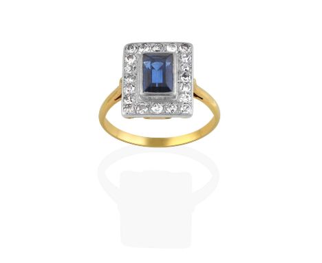 the rectangular step cut sapphire within a border of eight-cut diamonds, in white rubbed over and claw settings, to a yellow 