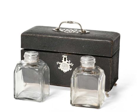 the oblong section glass caddies with faceted corners, the silver mounts engraved with foliage scroll and rocaille and later 