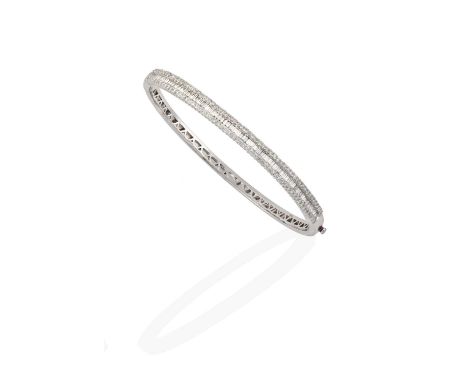 the baguette cut diamonds within a border of round brilliant cut diamonds, in claw settings, to a plain polished hinged back,