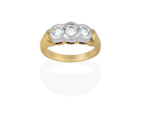 the round brilliant cut diamonds in white rubbed over settings, to a yellow plain polished shank, total estimated diamond wei