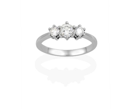the graduated round brilliant cut diamonds in claw settings, to a tapered shoulder plain polished shank, total estimated diam