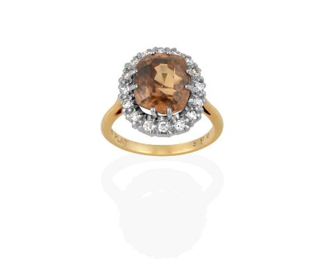 the cushion cut brown zircon within a border of eight-cut diamonds, in white claw settings, to a yellow tapered shoulder plai