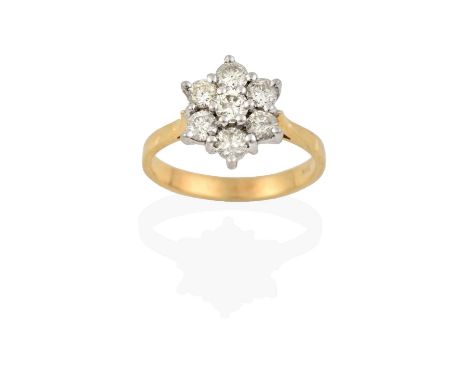 the raised round brilliant cut diamond within a border of round brilliant cut diamonds, in white claw settings, to a yellow t
