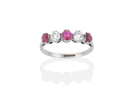 the three oval cut rubies alternate with two old cut diamonds, in white double claw settings, to a tapered shoulder plain pol