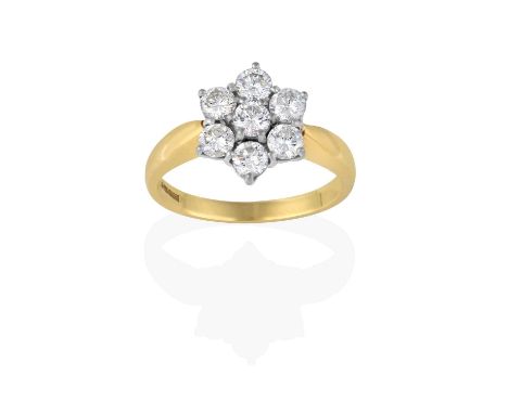 the cluster formed of round brilliant cut diamonds, in white claw settings, to a yellow tapered shoulder plain polished shank