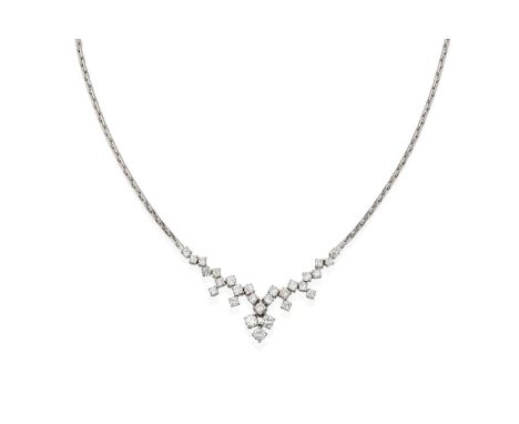 the central section composed of round brilliant cut diamonds suspends five round brilliant cut diamond drops, with a cluster 