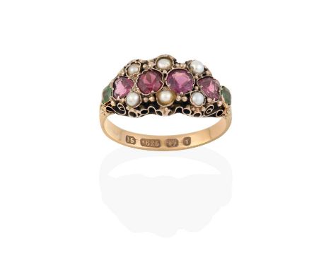 two round cut garnets, flanked by heart shaped garnets, terminating to cushion cut emeralds, with split pearl accents, in yel