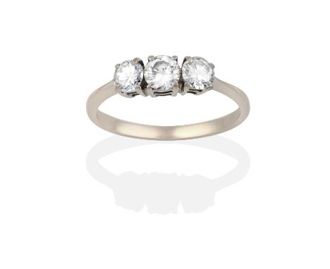 the round brilliant cut diamonds in white claw settings, to a tapered shoulder plain polished shank, total estimated diamond 