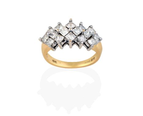 composed of five overlapping clusters of princess cut diamonds, in white claw settings, to a yellow tapered shoulder plain po