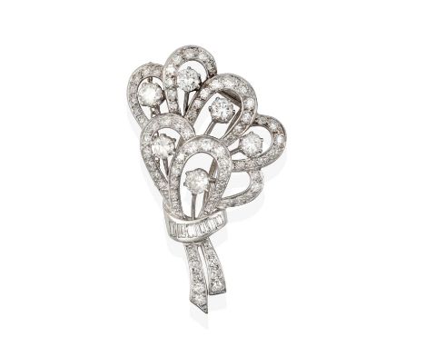 modelled as a stylised floral spray, set throughout with round brilliant and eight-cut diamonds, tied with a ribbon formed of