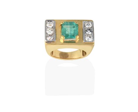 the emerald-cut emerald in a yellow claw setting, flanked by trios of old cut and round brilliant cut diamonds, in white claw