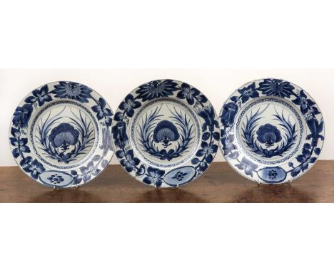 Set of three blue and white large platesChinese, Kangxi period (1662-1722)each painted with trailing foliate designs and with