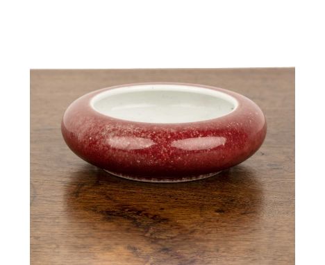 Monochrome brush washerChinesewith sang de boeuf glaze, and underglaze blue Kangxi mark, 12cm diameter x 3.6cm high  With a s
