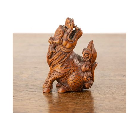 Boxwood carved netsukeJapanese, Meiji period (1868-1912)carved in the form of a snarling Chinese temple dog, signed ISHIKAWA,