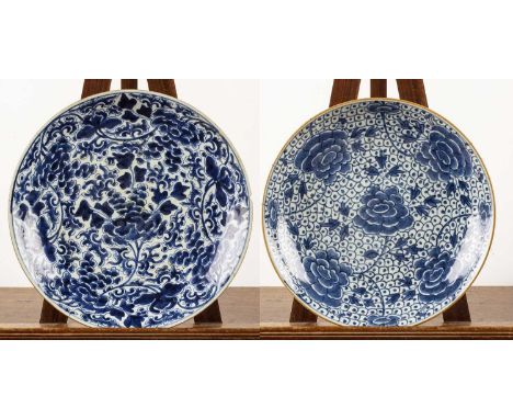 Two blue and white porcelain chargersChinese, 18th Centuryboth decorated with flowering peonies and one with a Kangxi Sacred 