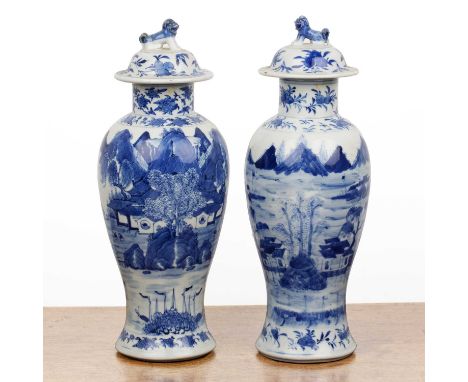 Pair of blue and white vases and coversChinese, 19th Centurypainted with river landscape scenes, with kylin finials, and with