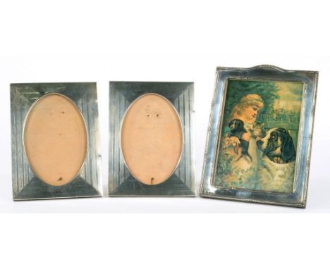 A PAIR OF GEORGE V SILVER PHOTOGRAPH FRAMES WITH OVAL APERTURE, ENGINE TURNED, 19.5 X 14CM, BIRMINGHAM 1917 AND ANOTHER CONTE