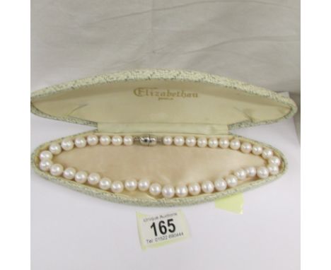 A cultured pearl necklace with large beads.