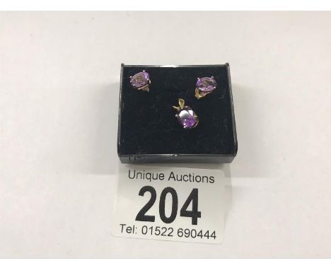 A 9ct gold pendant set amethyst with matching ear studs.