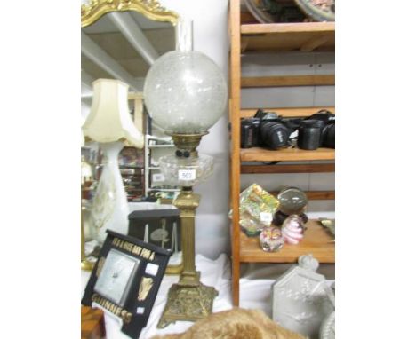 A Victorian brass column oil lamp with cut glass font, Sherwood's burner and acid etched shade.